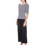 Woman wearing a striped shirt and wide-leg pants on a white background