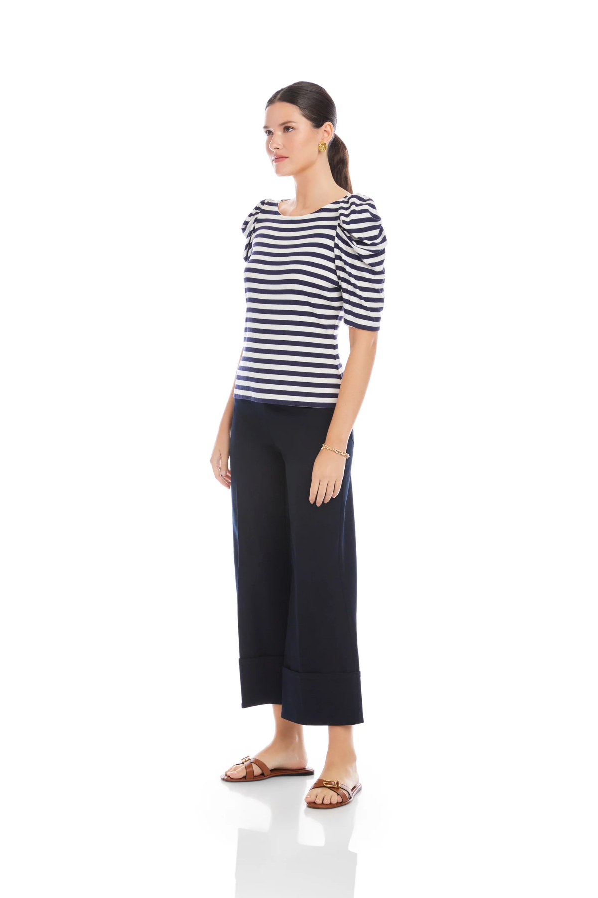 Woman wearing a striped shirt and wide-leg pants on a white background