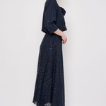 Model wearing a knee-length lace skirt with sequin detailing and a flattering fitted silhouette.