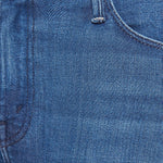 Woman wearing mid-wash flared jeans with a slim fit through the hip and gentle flare at the hem.