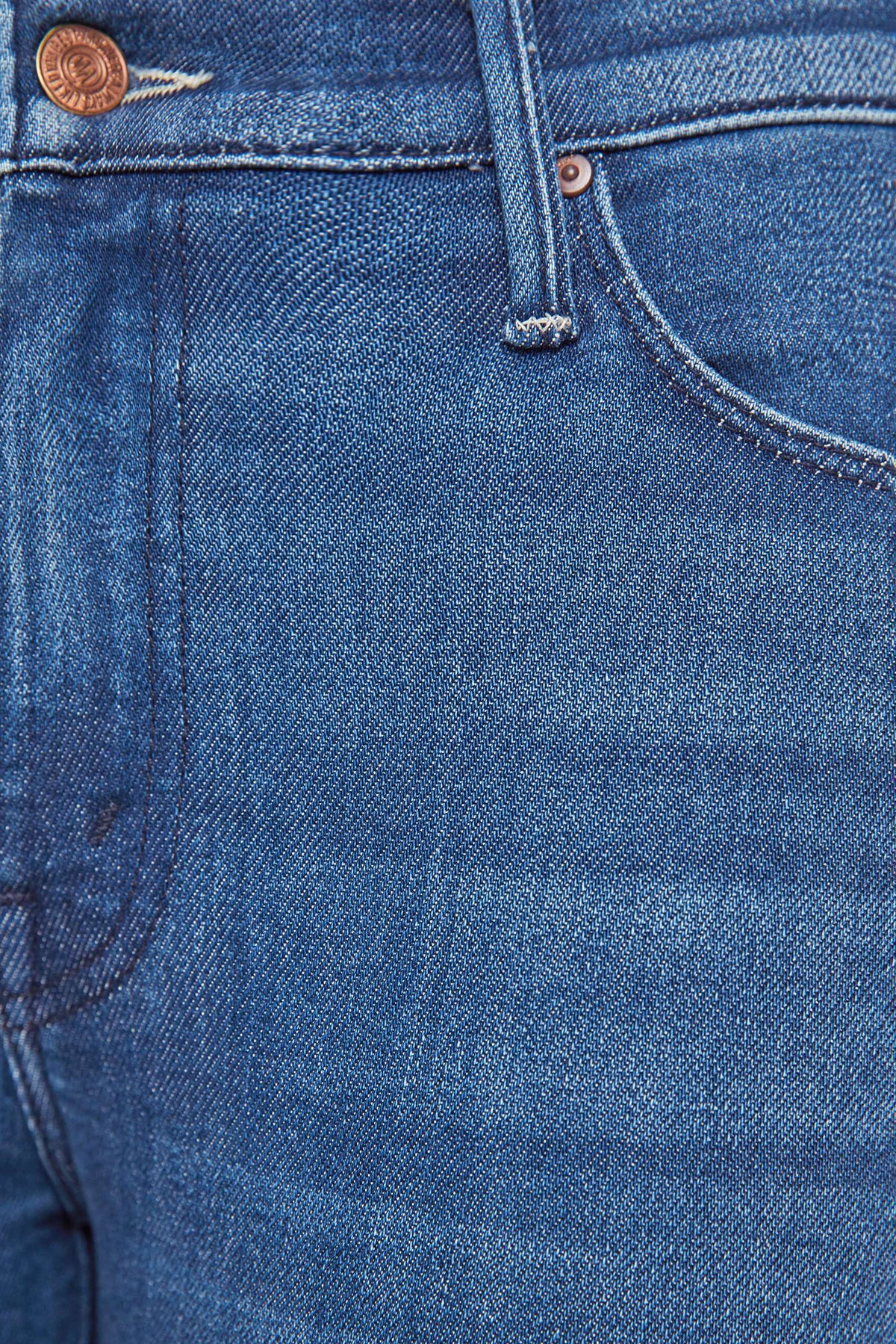 Woman wearing mid-wash flared jeans with a slim fit through the hip and gentle flare at the hem.