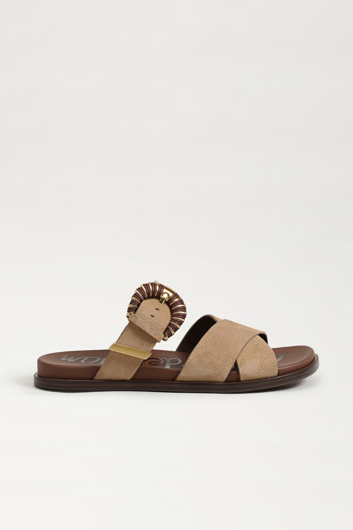 Beige sandal with lion head design on a white background