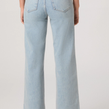 Light blue jeans worn by a person on a white background