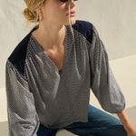 Neutral long-sleeve top styled casually with denim