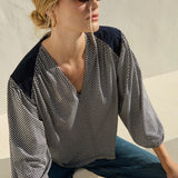 Neutral long-sleeve top styled casually with denim