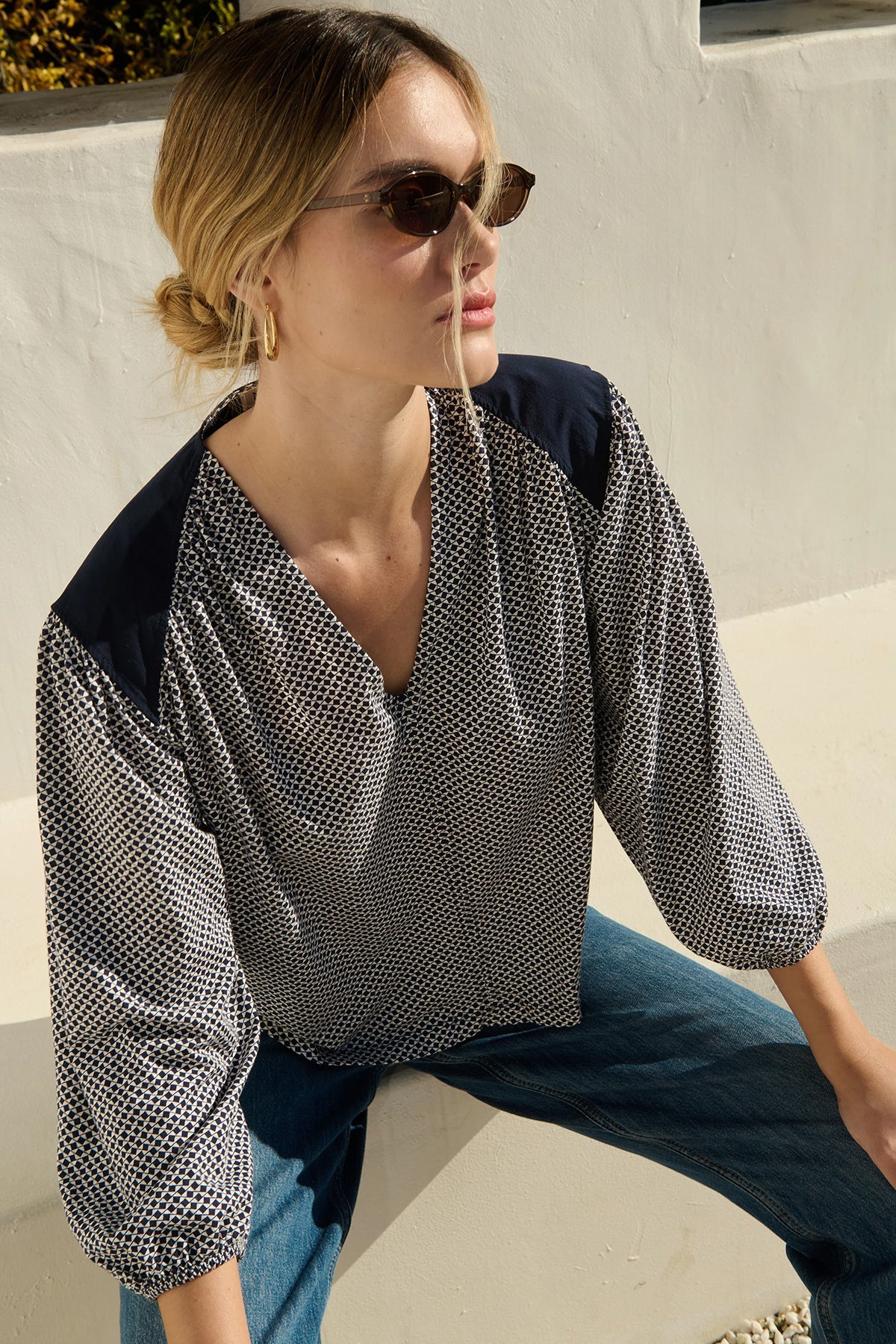 Neutral long-sleeve top styled casually with denim