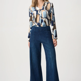 Person wearing blue pants against white background
