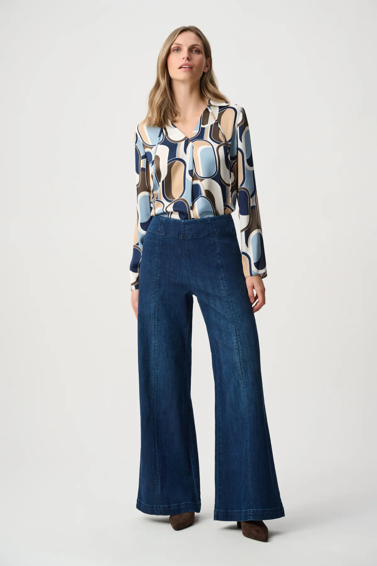 Person wearing blue pants against white background