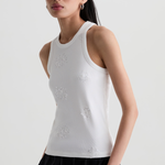 Model wearing a versatile solid-color top with a flattering silhouette styled with tailored black pants.
