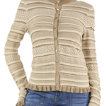 Beige patterned cardigan worn by a person on a white background