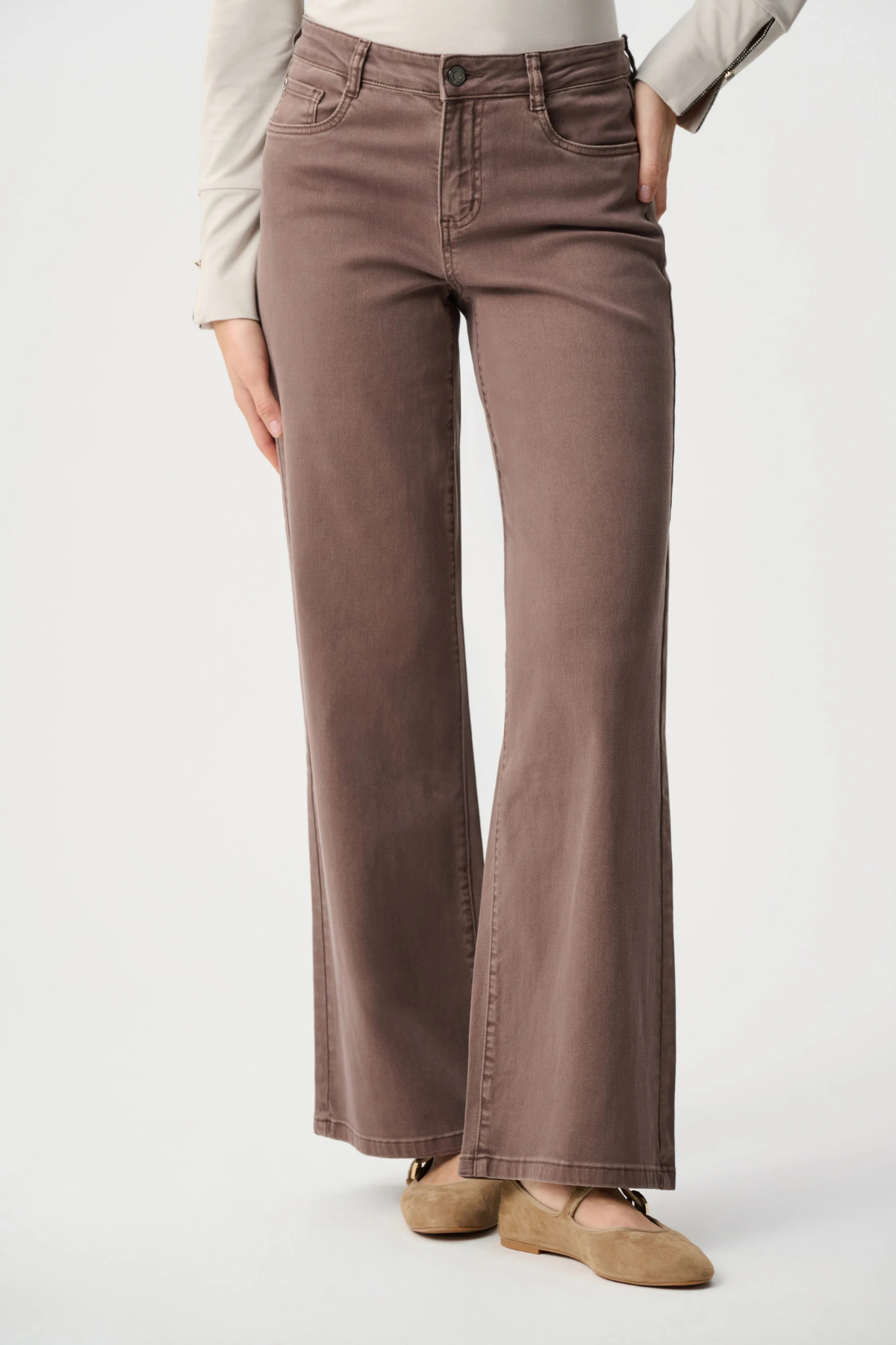 Brown pants worn by a person on a white background
