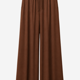 A pair of brown wide-leg cropped pants with an elastic waistband and drawstring, shown against a plain light gray background.