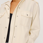 Beige jacket worn by a person on a white background