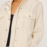 Beige jacket worn by a person on a white background