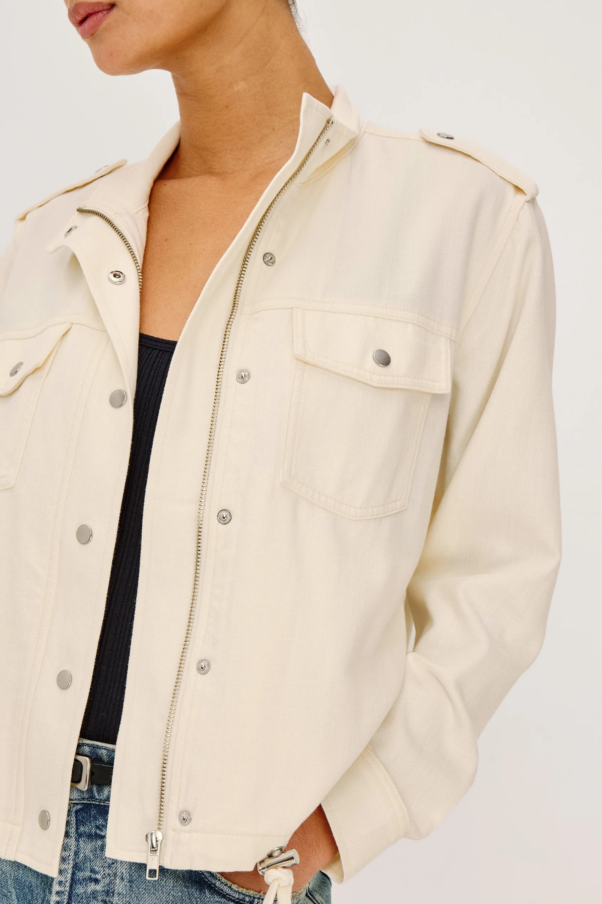 Beige jacket worn by a person on a white background