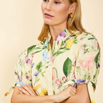 Woman wearing a floral dress with a beige background