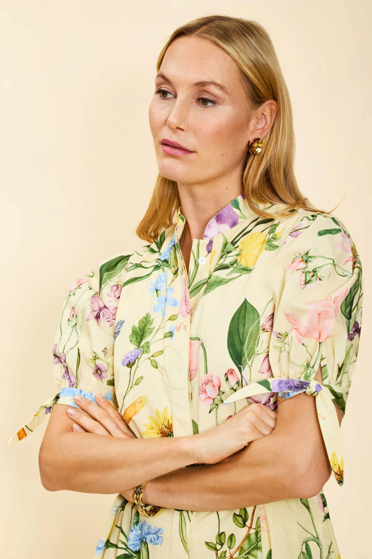 Woman wearing a floral dress with a beige background