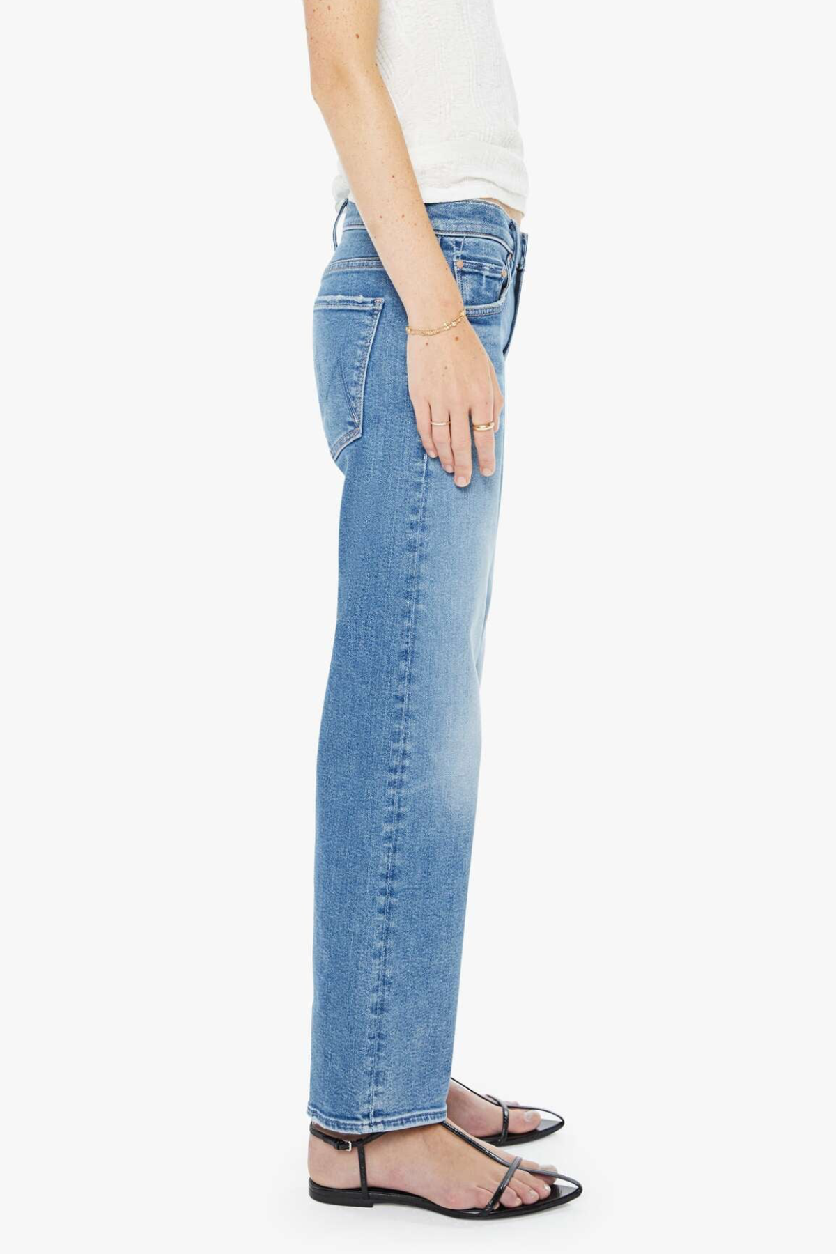 Person wearing light blue jeans on a white background