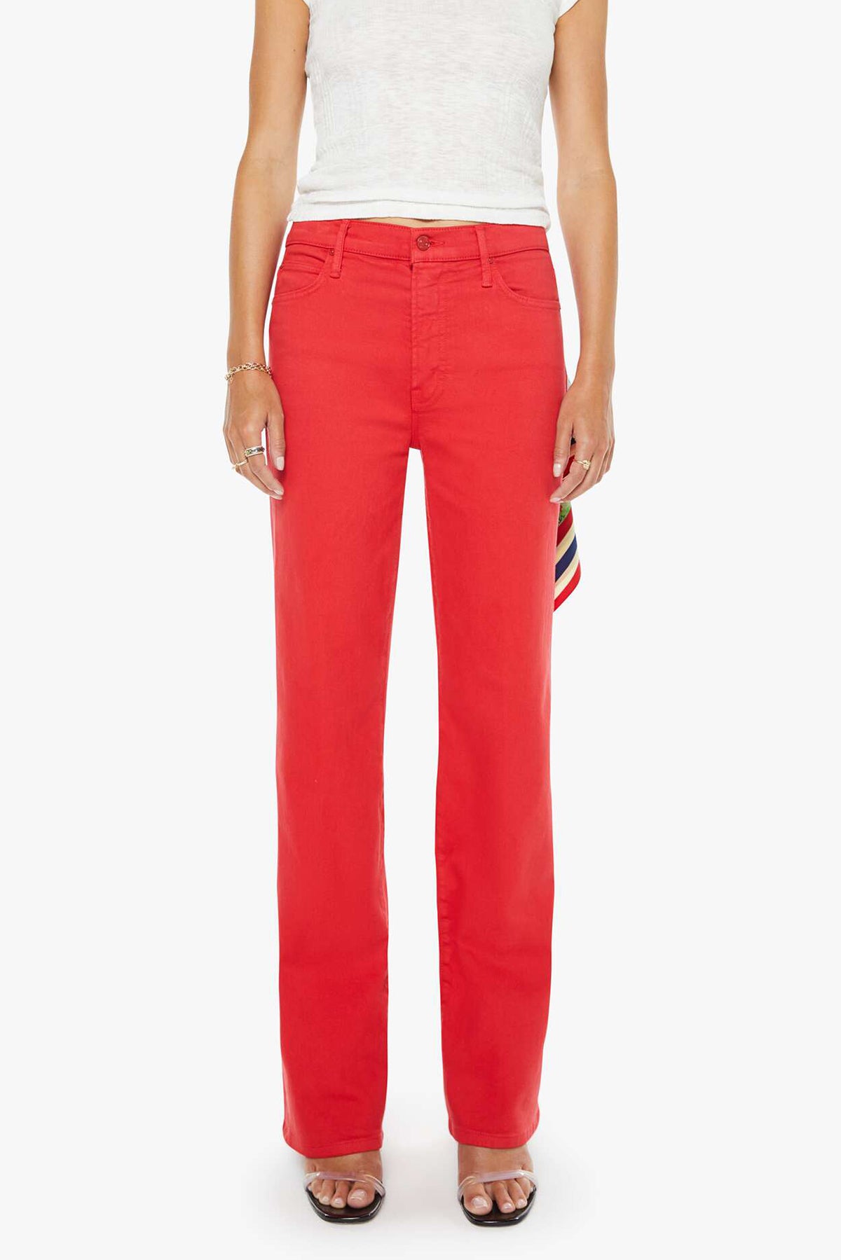 Person wearing bright red pants with a white top on a white background