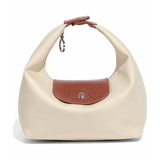 Beige handbag with brown leather patch on a white background