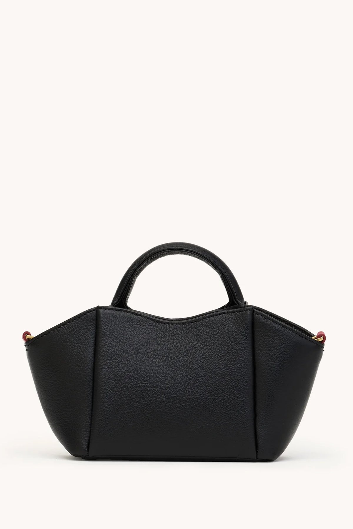 Black Hammitt Paul Mini crossbody bag worn with an evening outfit.