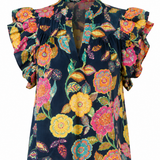 Colorful floral blouse with ruffled sleeves on a white background