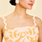 close up of woman in orange embroidered dress
