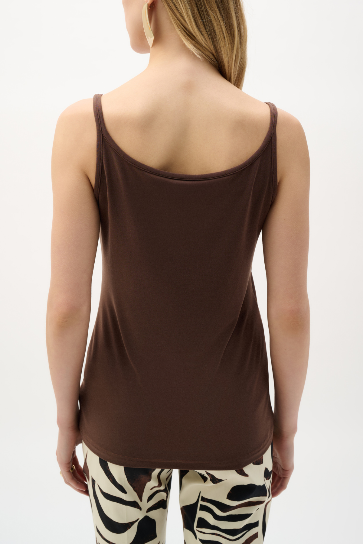 Brown tank top worn by a person on a white background