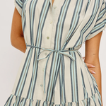Woman wearing a striped dress with a white background