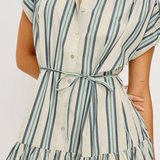 Woman wearing a striped dress with a white background