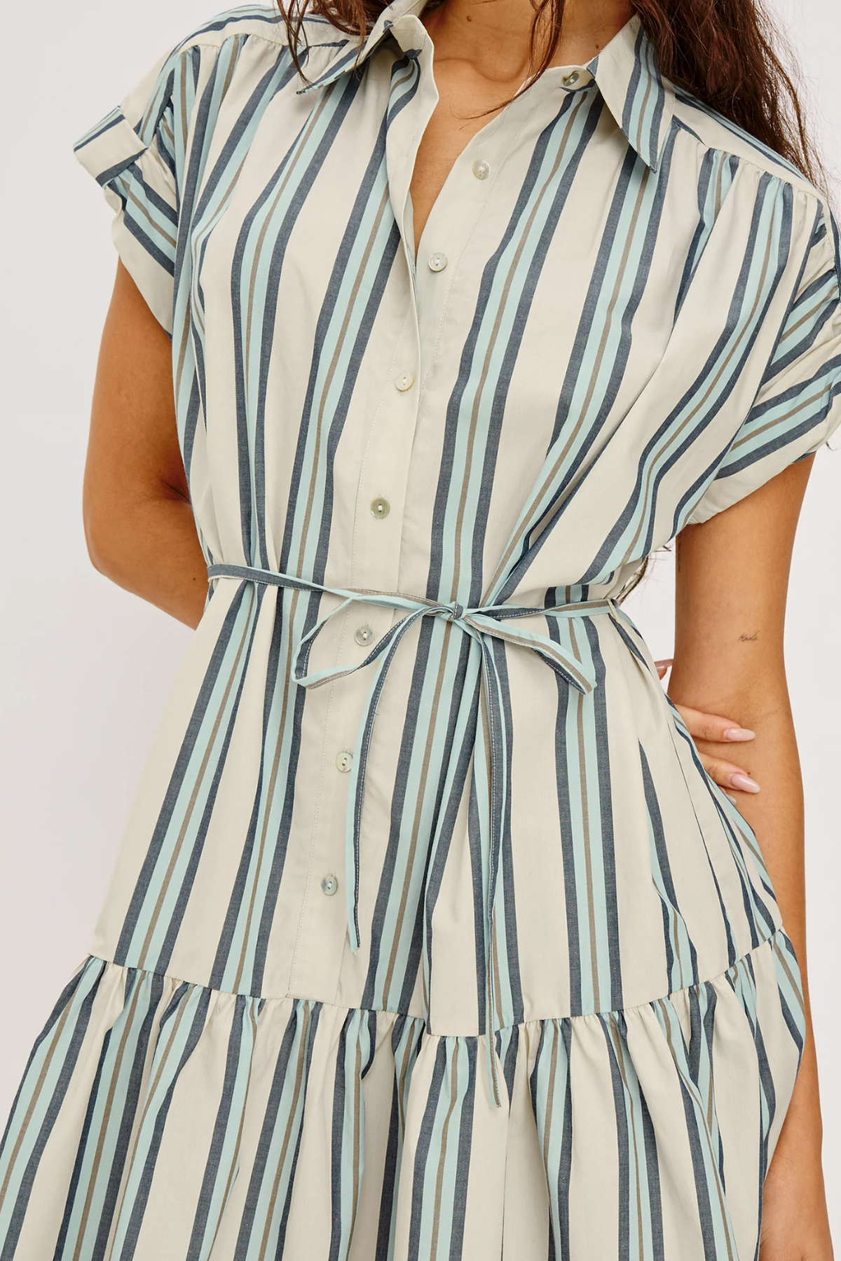 Woman wearing a striped dress with a white background