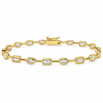 A yellow gold tennis bracelet featuring alternating rectangular baguette and oval-cut clear gemstones, displayed on a clean white background.