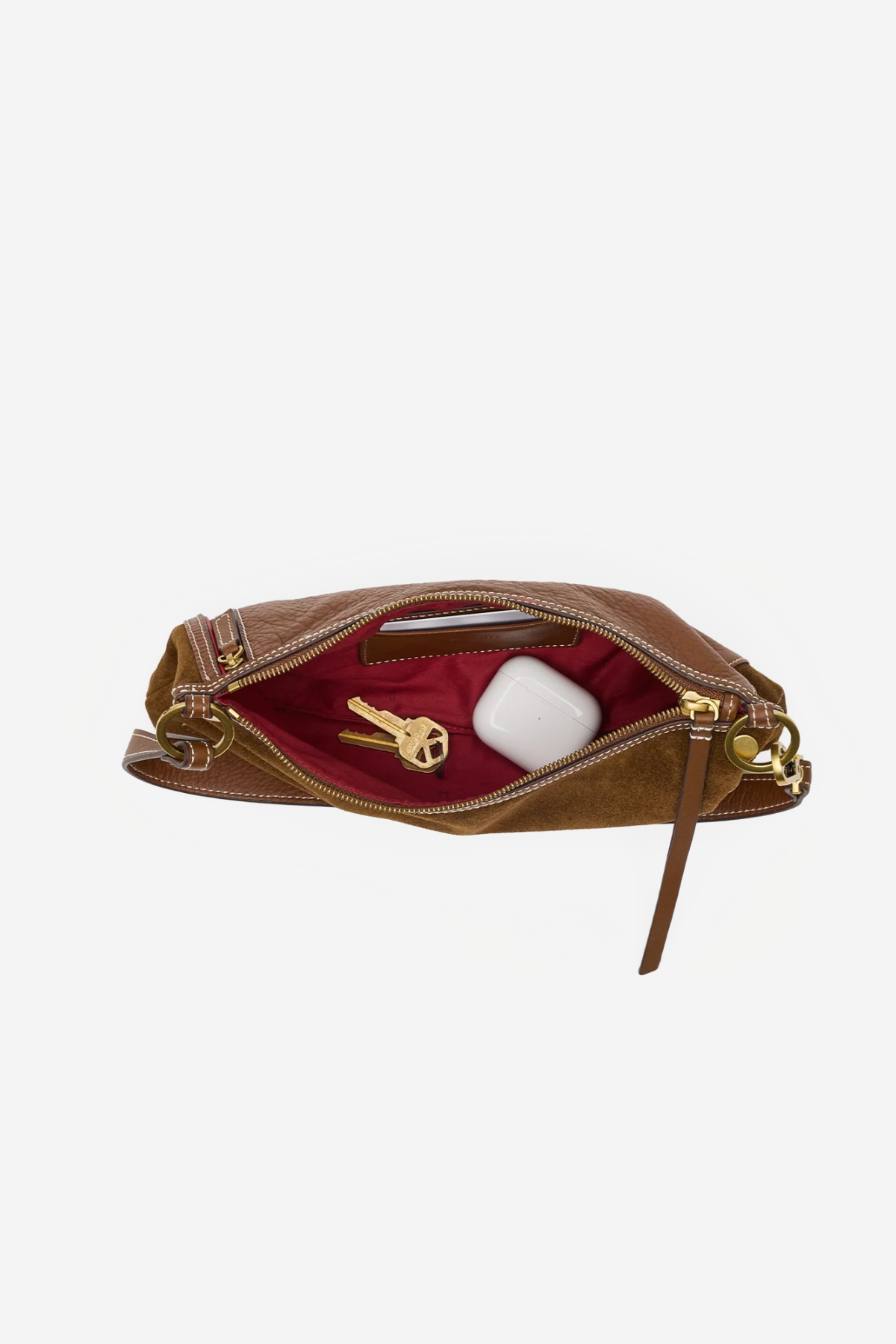 A brown leather zippered pouch shown open against a light gray background, revealing a deep burgundy interior with a gold key and a white wireless earbud case inside.