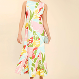 Woman wearing a colorful floral dress on a beige background