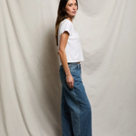 side of woman in white t-shirt and denim 