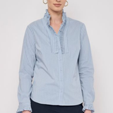 Model wearing a striped long-sleeve blouse with ruffle detailing and a relaxed, polished silhouette.