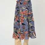 Woman wearing a mid-length printed skirt with fluid movement and refined drape