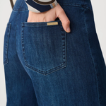 Person wearing blue pants against white background