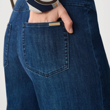 Person wearing blue pants against white background