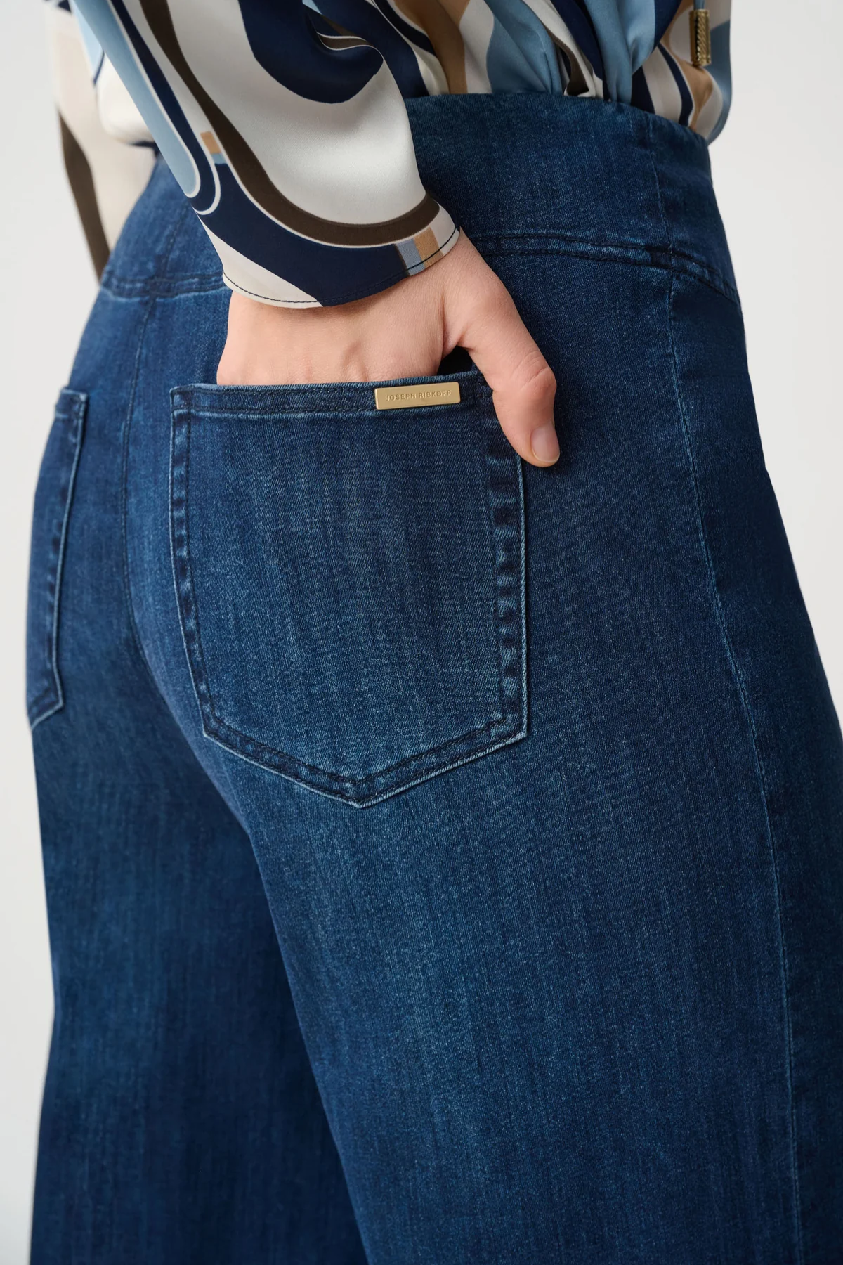 Person wearing blue pants against white background