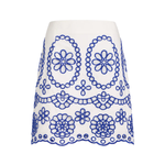 White skirt with blue floral embroidery on a white background