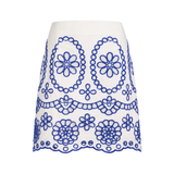 White skirt with blue floral embroidery on a white background
