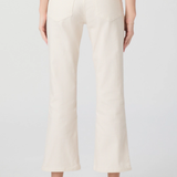 Person wearing white ribbed pants on a plain background