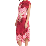 Model wearing a vibrant pink printed short-sleeve midi dress with an asymmetrical hem and flowing silhouette.