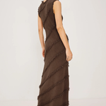 Woman wearing a brown ruffled dress on a white background