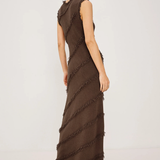 Woman wearing a brown ruffled dress on a white background