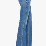 Blue jeans worn by a person on a white background