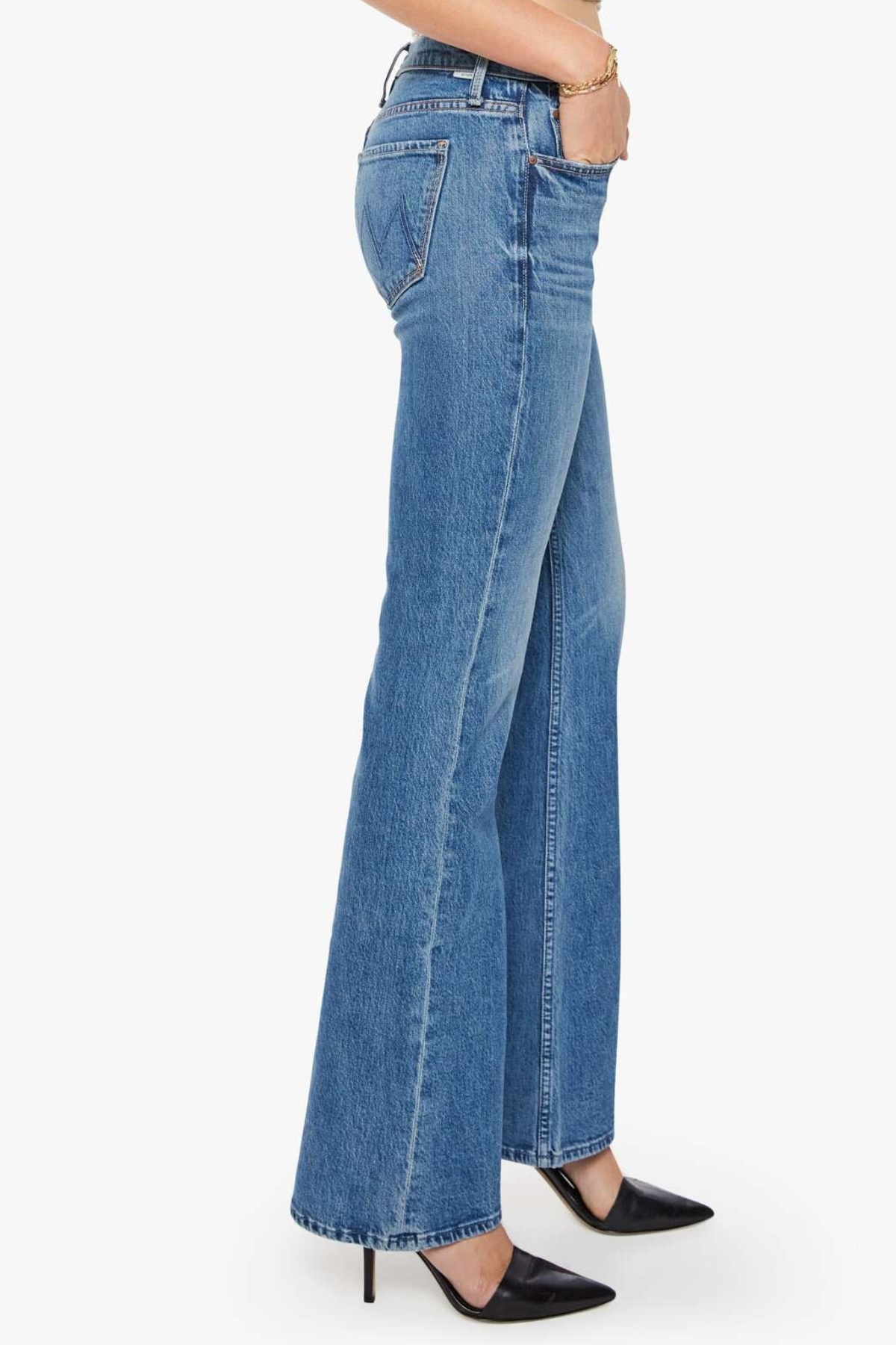 Blue jeans worn by a person on a white background