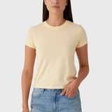 Woman wearing a light yellow t-shirt and denim shorts on a white background