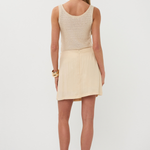 back of woman in neutral outfit 